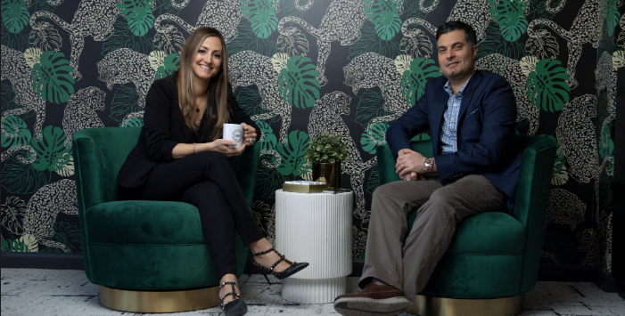 Liz Rocco and Joe Rocco seated together in green chairs